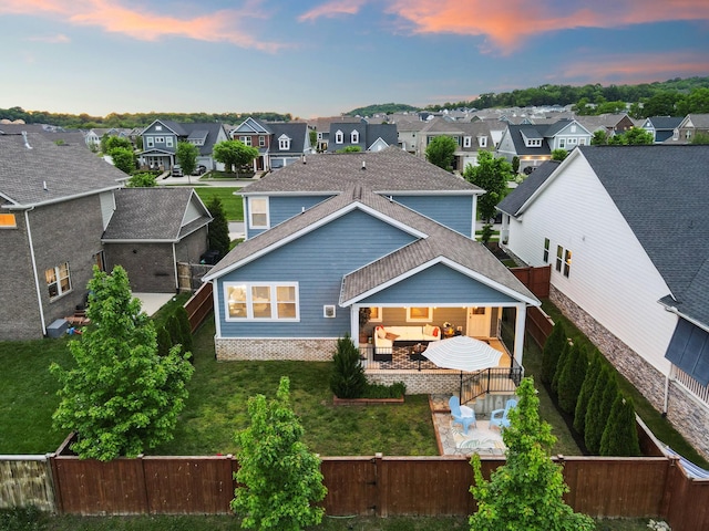 back of property with a patio area, a residential view, an outdoor living space, and roof with shingles