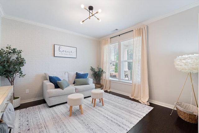 living area featuring a chandelier, wood finished floors, baseboards, and ornamental molding
