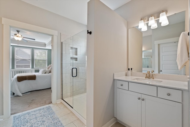 bathroom with a stall shower, connected bathroom, baseboards, and vanity