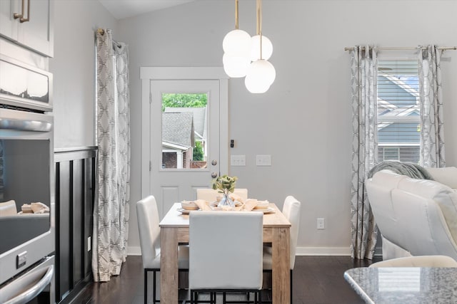 dining space with dark wood-style floors and baseboards