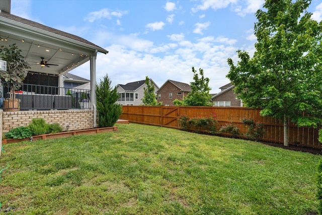 view of yard featuring a ceiling fan and a residential view