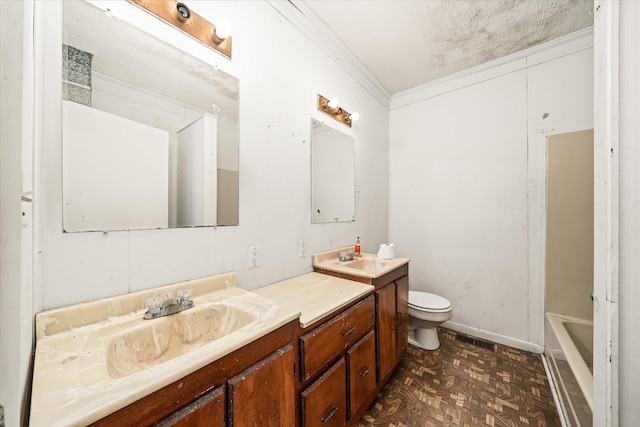 bathroom with double vanity, toilet, a bathtub, and ornamental molding