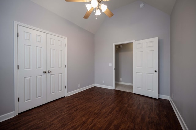 unfurnished bedroom with dark wood finished floors, high vaulted ceiling, a ceiling fan, a closet, and baseboards