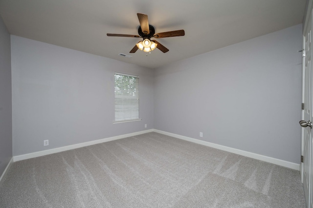 unfurnished room with carpet, a ceiling fan, and baseboards