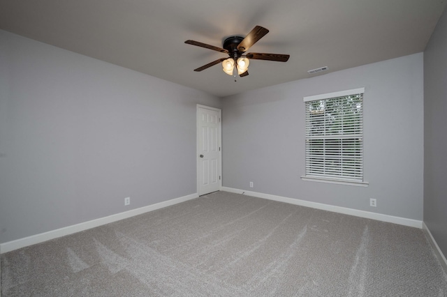 empty room featuring carpet floors, ceiling fan, and baseboards
