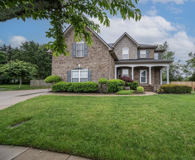 traditional-style home featuring brick siding and covered porch