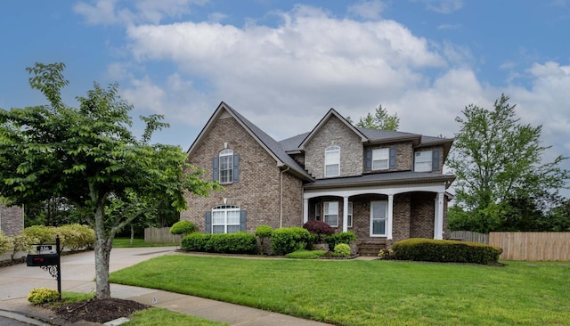 336 Foundry Cir, Murfreesboro, TN 37128 - traditional home with brick siding, a porch, and driveway