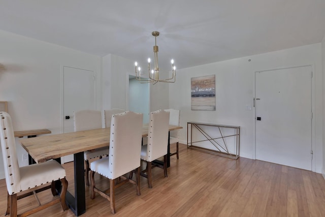 dining room featuring a chandelier and light wood-type flooring