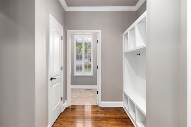 mudroom with crown molding, dark wood finished floors, and baseboards
