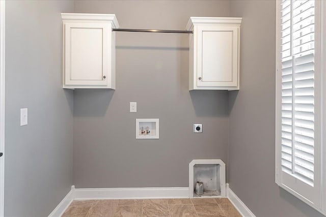 laundry room featuring hookup for an electric dryer, washer hookup, baseboards, and cabinet space