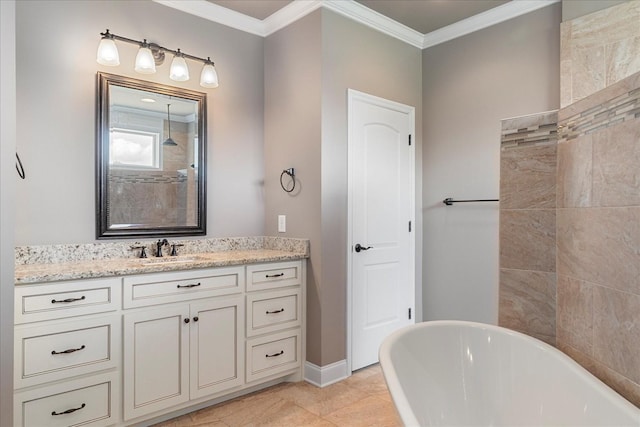 bathroom with a freestanding bath, vanity, crown molding, and baseboards