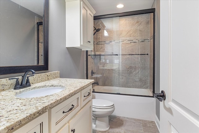 bathroom featuring toilet, recessed lighting, vanity, and combined bath / shower with glass door