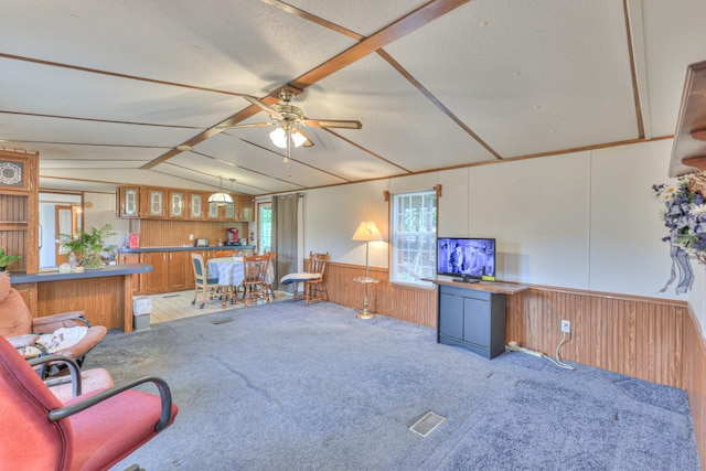 1687 Columbia Rock Rd, Columbia, TN 38401 - carpeted living area featuring wooden walls, vaulted ceiling, a ceiling fan, and a wainscoted wall