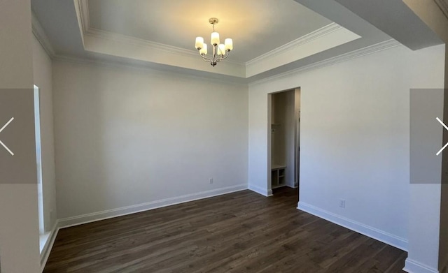 6158 Worthingtion Rd, Columbia, TN 38401 - spare room featuring a raised ceiling, a chandelier, dark wood-style flooring, and ornamental molding