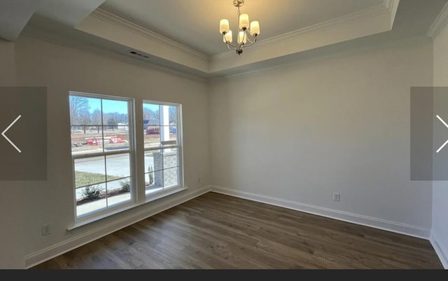 6158 Worthingtion Rd, Columbia, TN 38401 - spare room featuring a tray ceiling, a chandelier, ornamental molding, and dark wood-style flooring