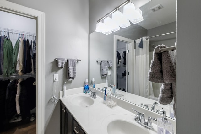 589 Smoky Mountains Dr, Gallatin, TN 37066 - bathroom featuring a spacious closet, double vanity, and curtained shower