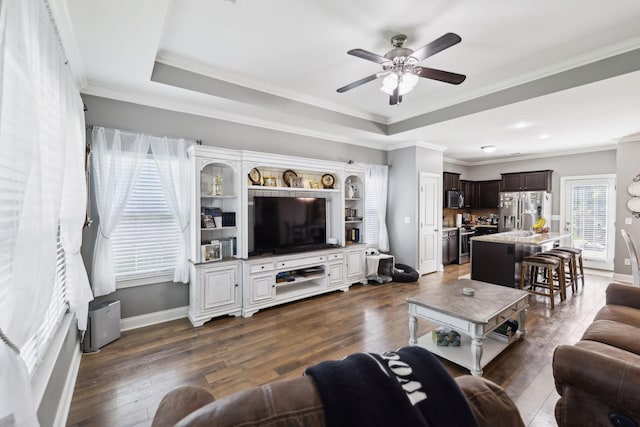 589 Smoky Mountains Dr, Gallatin, TN 37066 - living area with a ceiling fan, a raised ceiling, dark wood-style floors, baseboards, and crown molding