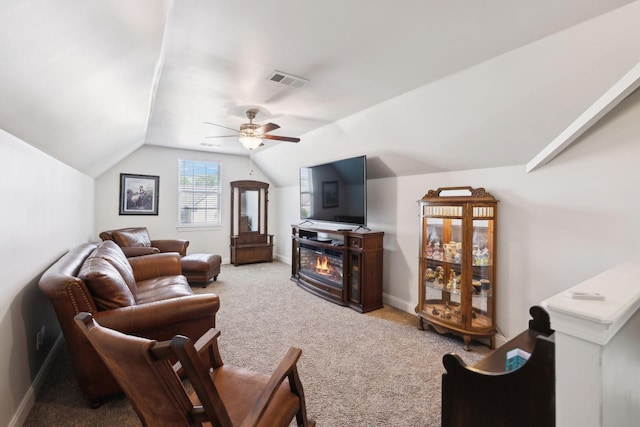 589 Smoky Mountains Dr, Gallatin, TN 37066 - carpeted living room featuring a ceiling fan, vaulted ceiling, a glass covered fireplace, and baseboards