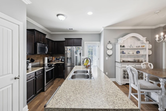 589 Smoky Mountains Dr, Gallatin, TN 37066 - kitchen featuring appliances with stainless steel finishes, a sink, an island with sink, light countertops, and dark wood-type flooring