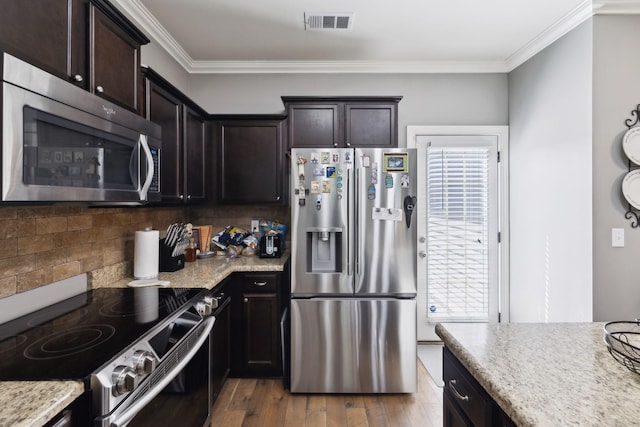 589 Smoky Mountains Dr, Gallatin, TN 37066 - kitchen with appliances with stainless steel finishes, decorative backsplash, crown molding, wood finished floors, and dark brown cabinetry