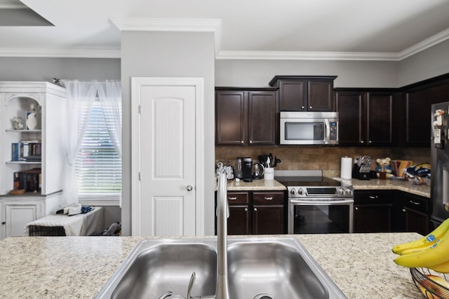 589 Smoky Mountains Dr, Gallatin, TN 37066 - kitchen with stainless steel appliances, a sink, light countertops, decorative backsplash, and crown molding