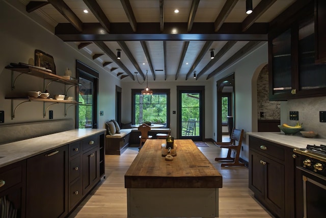 5564 Wilkins Branch Rd, Franklin, TN 37064 - kitchen with wood counters, beam ceiling, open shelves, light wood-type flooring, and arched walkways