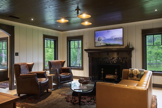 5564 Wilkins Branch Rd, Franklin, TN 37064 - living area featuring ornamental molding, a decorative wall, arched walkways, a fireplace, and healthy amount of natural light