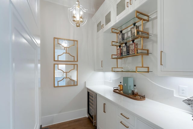 1461 Witherspoon Dr, Brentwood, TN 37027 - indoor bar featuring beverage cooler, dark wood-style floors, baseboards, a chandelier, and hanging light fixtures