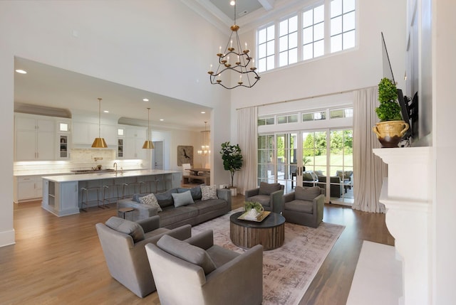 1461 Witherspoon Dr, Brentwood, TN 37027 - living area featuring a chandelier, healthy amount of natural light, a towering ceiling, wood finished floors, and recessed lighting