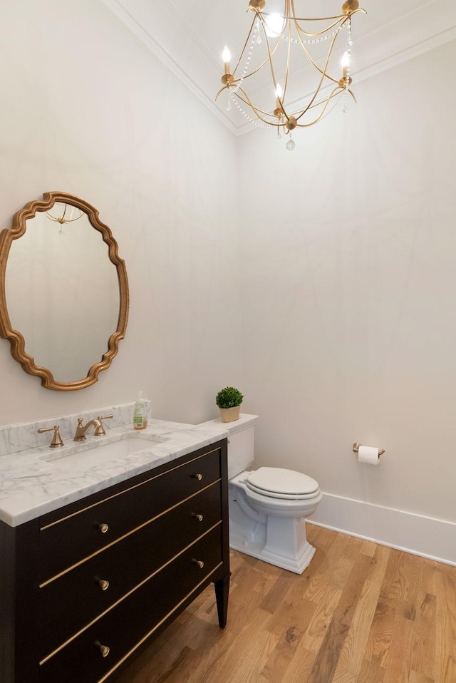 1461 Witherspoon Dr, Brentwood, TN 37027 - half bathroom featuring wood finished floors, ornamental molding, toilet, vanity, and a chandelier