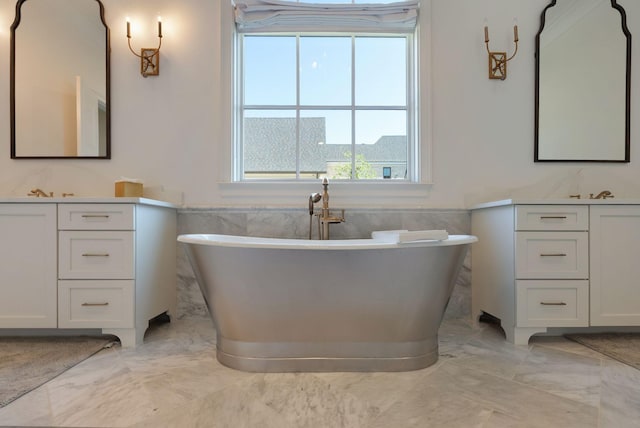 1461 Witherspoon Dr, Brentwood, TN 37027 - bathroom featuring marble tiled floors, wainscoting, tile walls, vanity, and a freestanding tub