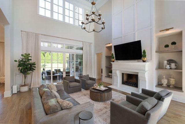 1461 Witherspoon Dr, Brentwood, TN 37027 - living room with a towering ceiling, light wood-style flooring, built in features, a fireplace, and plenty of natural light