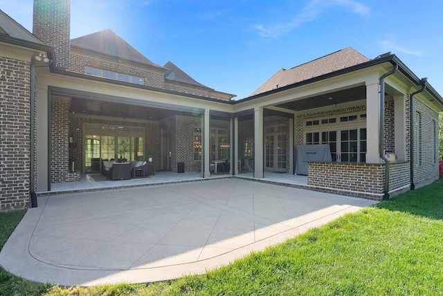 1461 Witherspoon Dr, Brentwood, TN 37027 - back of house featuring brick siding, a patio, an outdoor hangout area, french doors, and a chimney