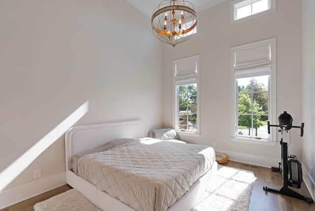 1461 Witherspoon Dr, Brentwood, TN 37027 - bedroom with a chandelier, a high ceiling, baseboards, and wood finished floors