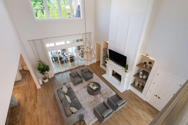 1461 Witherspoon Dr, Brentwood, TN 37027 - living area with a towering ceiling, wood finished floors, plenty of natural light, and a fireplace