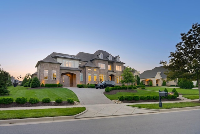 1461 Witherspoon Dr, Brentwood, TN 37027 - french country home with curved driveway, a yard, and brick siding