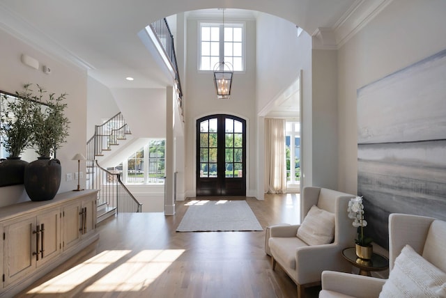 1461 Witherspoon Dr, Brentwood, TN 37027 - entrance foyer with arched walkways, wood finished floors, a high ceiling, stairway, and ornamental molding