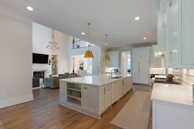1461 Witherspoon Dr, Brentwood, TN 37027 - kitchen with a sink, light countertops, white cabinets, wood finished floors, and open floor plan