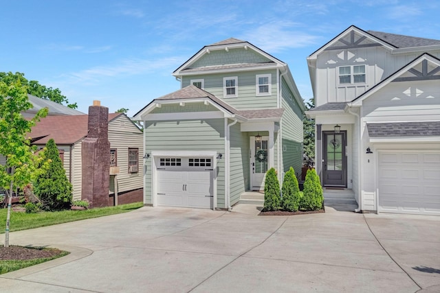 craftsman-style home featuring concrete driveway, an attached garage, and roof with shingles
