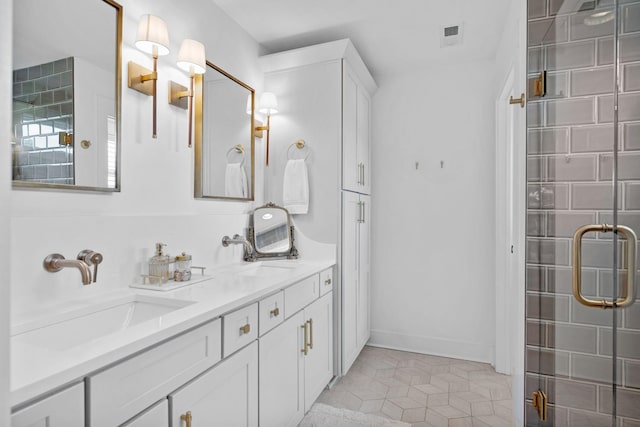 bathroom featuring a shower stall, tile patterned flooring, double vanity, and baseboards