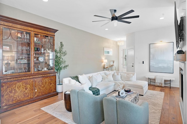 living area with a ceiling fan, wood finished floors, and recessed lighting