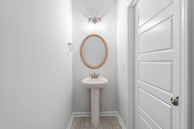 209 Wesson Dr, Clarksville, TN 37043 - bathroom featuring baseboards, wood finished floors, and a sink