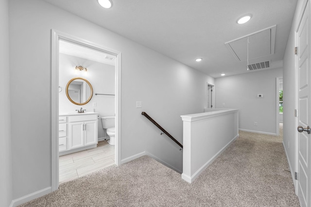 209 Wesson Dr, Clarksville, TN 37043 - hall featuring attic access, light colored carpet, an upstairs landing, a sink, and recessed lighting