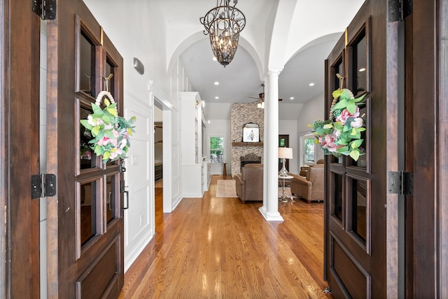 3031 Trice Pl, Lebanon, TN 37087 - entryway with arched walkways, decorative columns, a fireplace, light wood finished floors, and ceiling fan