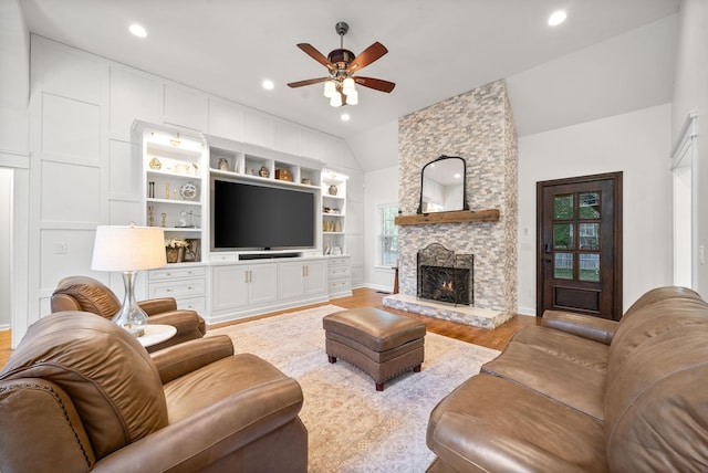 3031 Trice Pl, Lebanon, TN 37087 - living area with a ceiling fan, light wood-type flooring, a stone fireplace, lofted ceiling, and built in features