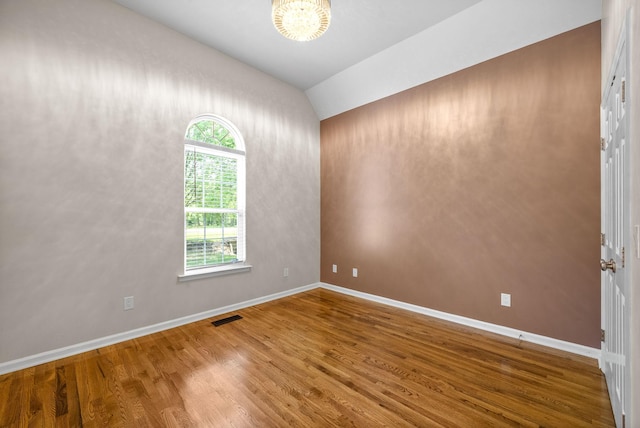 3031 Trice Pl, Lebanon, TN 37087 - spare room featuring wood finished floors, a chandelier, vaulted ceiling, and baseboards