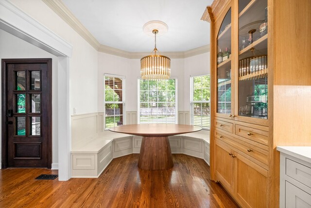 3031 Trice Pl, Lebanon, TN 37087 - dining space featuring wood finished floors, a wainscoted wall, a chandelier, breakfast area, and crown molding