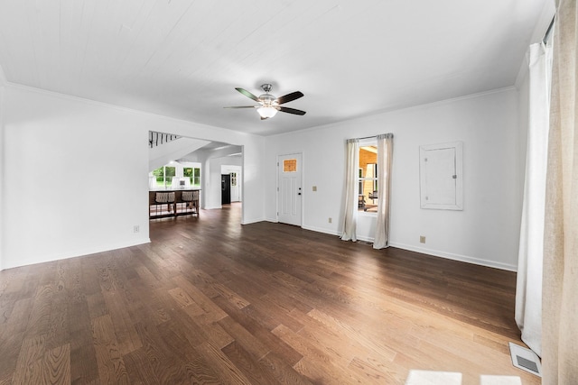 unfurnished living room with a ceiling fan, wood finished floors, baseboards, and ornamental molding