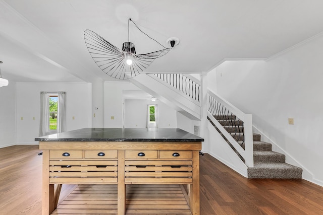kitchen with dark wood-style flooring, plenty of natural light, a chandelier, and ornamental molding