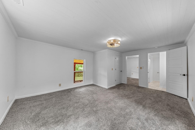 unfurnished bedroom featuring carpet floors, crown molding, and baseboards
